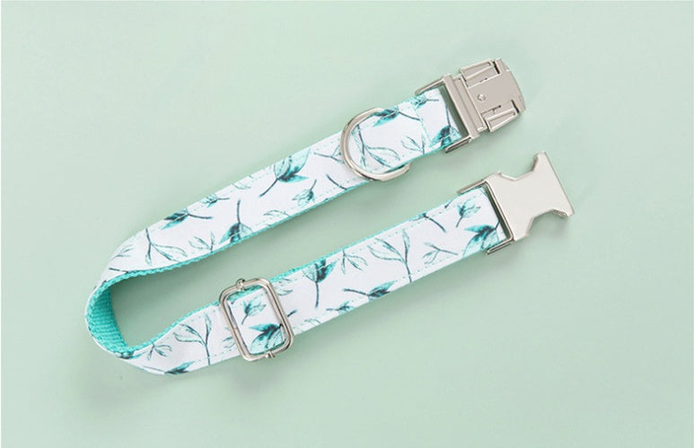 Adjustable collar with metal buckle and D-ring featuring tropical leaf pattern