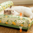 Load image into Gallery viewer, Close-up of a cat lying on the cooling bolster pet bed showing the 10cm height of the lemon pattern bolster support.

