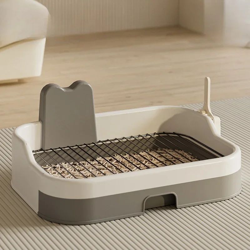 Beige and gray dog potty tray from side angle with metal grate resting on top
