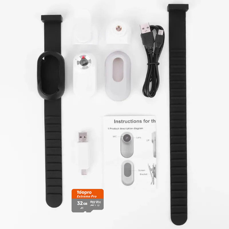 White camera components, black collars, cables, memory card, and instruction leaflet laid out