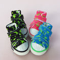 Cargar la imagen en la vista de la galería, Three colorful high-top dog sneakers in black, pink, and blue with green star patterns and white rubber toe caps.
