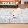 Load image into Gallery viewer, White fluffy dog lying comfortably on a textured light gray dog bed with text overlay about extreme comfort and joint support
