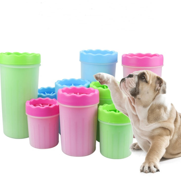 Multiple silicone dog paw washers in pink, blue, and green with a pug dog lifting paw