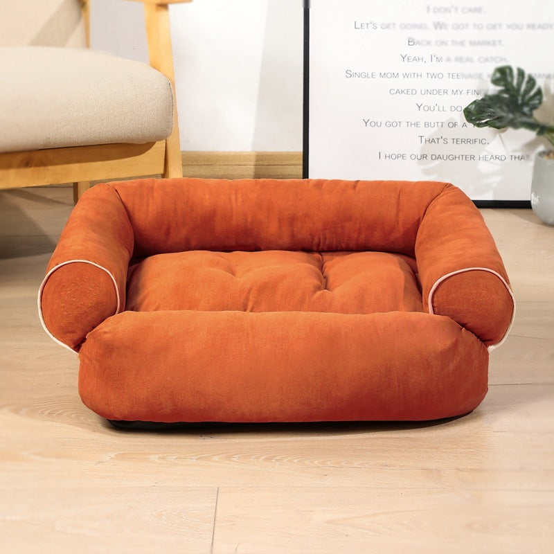 Burnt orange plush pet sofa bed with pipe trim shown on wooden floor