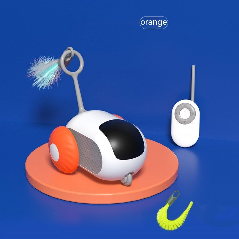 White and black remote control cat toy with orange wheels and feather attachment on orange base next to remote on blue background