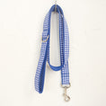 Load image into Gallery viewer, Blue plaid dog leash hanging from a hook on white wall
