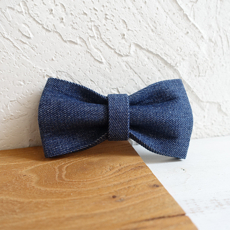Detachable denim bow tie accessory for dog collar on wooden surface
