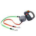 Load image into Gallery viewer, Black and gray dual retractable dog leash with orange and green nylon straps fully extended on white background

