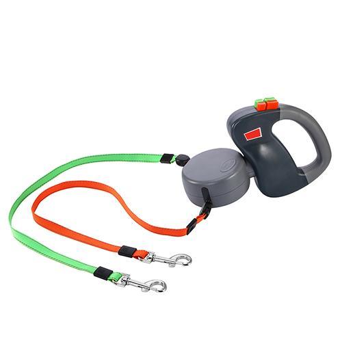 Black and gray dual retractable dog leash with orange and green nylon straps fully extended on white background