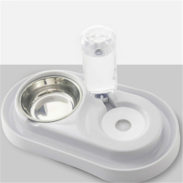 White automatic pet feeding station with stainless steel bowl and water dispenser on light gray background