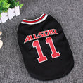 Load image into Gallery viewer, Black All-Star dog vest laid flat on grey surface near green plant
