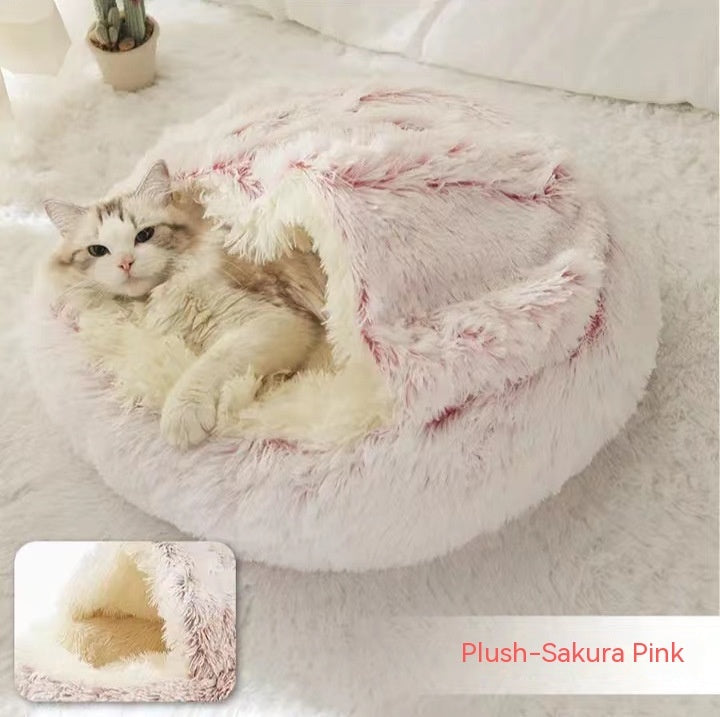 Cat lying inside pastel pink plush dome bed labeled Plush-Sakura Pink