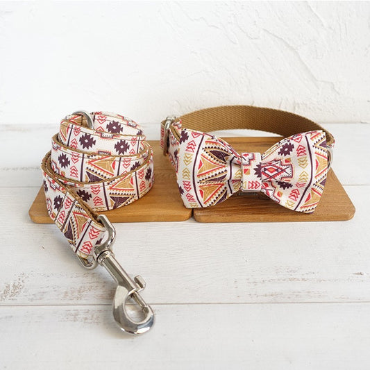 Print dog leash and bow tie collar set laid out on wooden boards