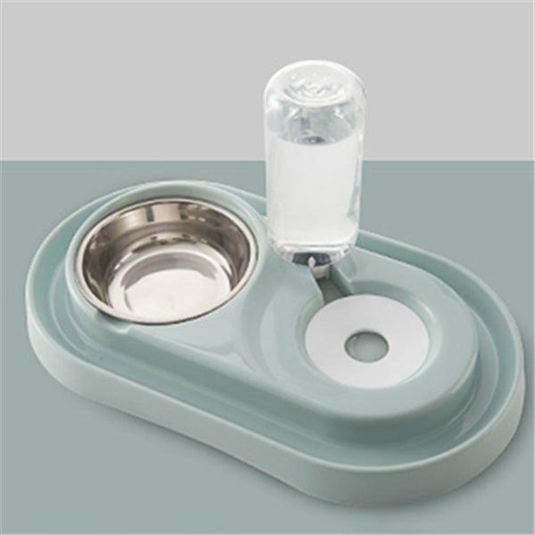 Green automatic pet feeding station with stainless steel food bowl and attached water bottle on gray surface