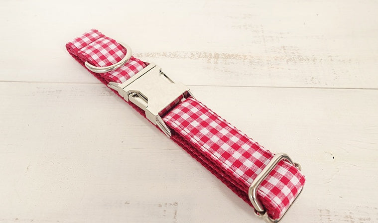 Full length of red and white checkered dog collar laid flat on white background
