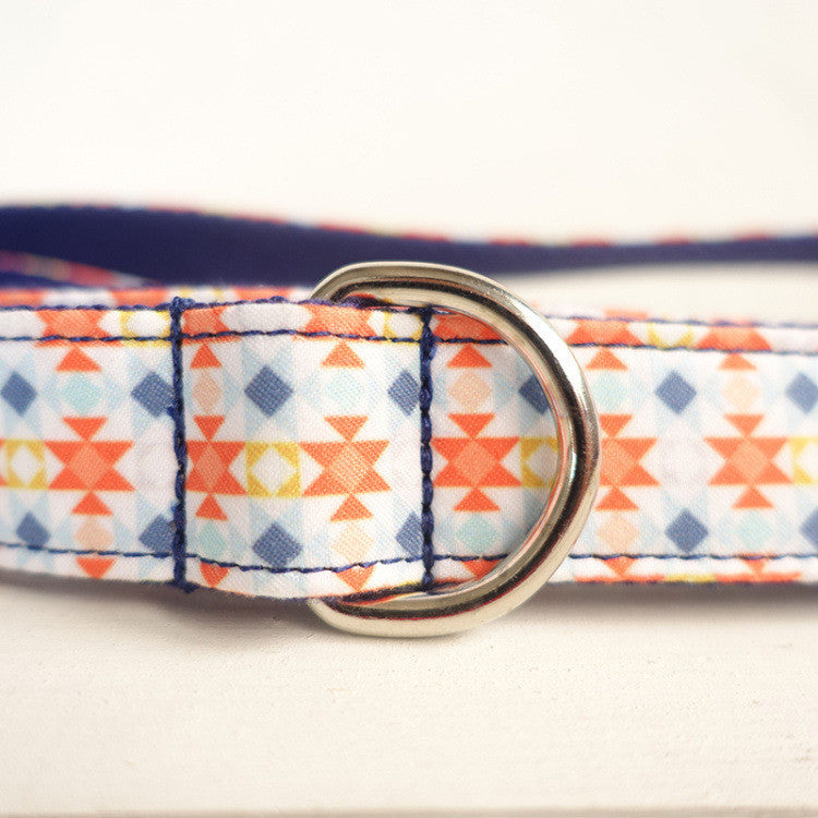 Close-up of metal D-ring attached to patterned polyester leash