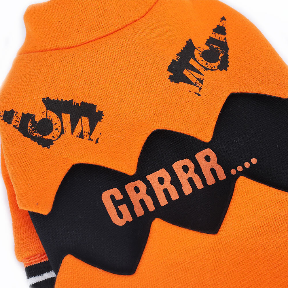 Close-up detail of orange pumpkin dog sweater showing 'MEOW' and 'GRRRR...' text graphics