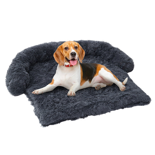 Beagle dog lying relaxed on dark gray extended plush pet mat nest on white background
