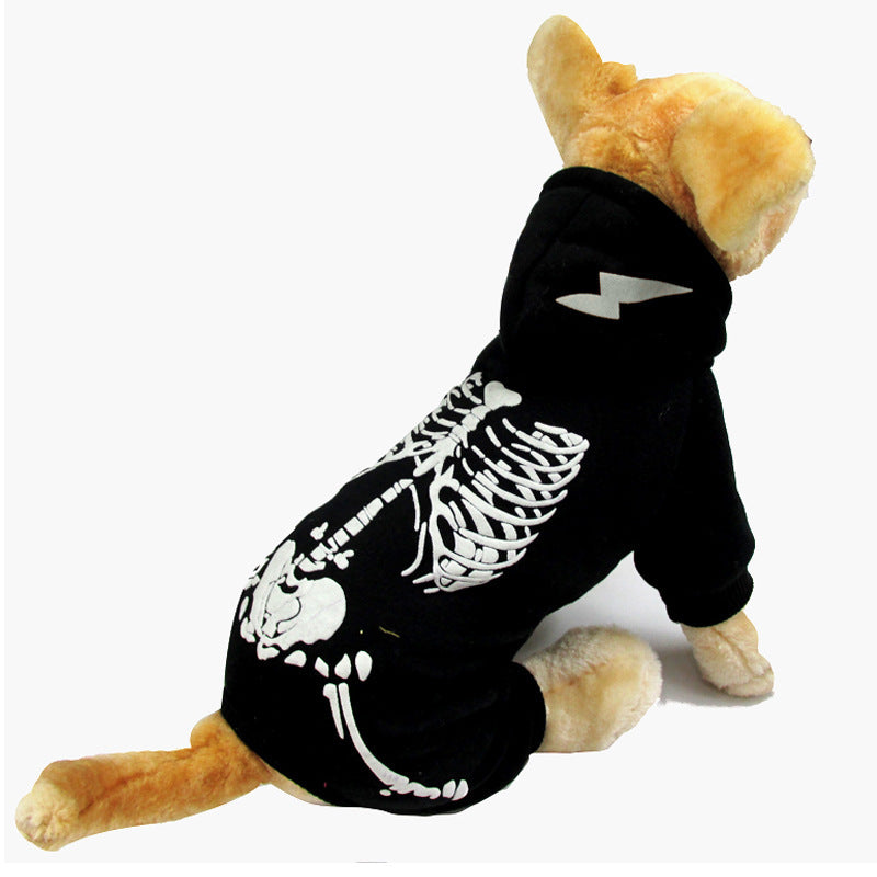 Small dog model wearing black skeleton print hooded jumpsuit with lightning bolt design on hood