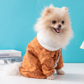 Load image into Gallery viewer, Small fluffy dog wearing orange-brown dog jacket with white fleece collar sitting indoors

