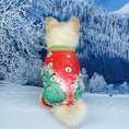 Charger l'image dans la visionneuse de la galerie, Small dog from behind in green and red pajamas adorned with Santa faces and candy cane prints against a snowy forest background
