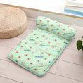 Cargar la imagen en la vista de la galería, Green cooling pet mat featuring avocado fruit print and attached bolster pillow placed on wooden floor near a woven seat

