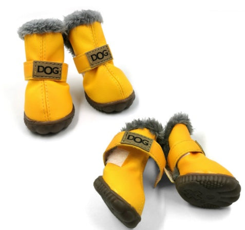 Bright yellow dog boots with gray faux fur lining and rubber sole, one boot laid open