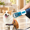 Load image into Gallery viewer, Tan and white corgi beside an Indigo pet bottle held in a cream interior
