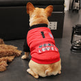 Cargar la imagen en la vista de la galería, Rear view of small tan French Bulldog seated on floor wearing red and black Next Level dog jacket
