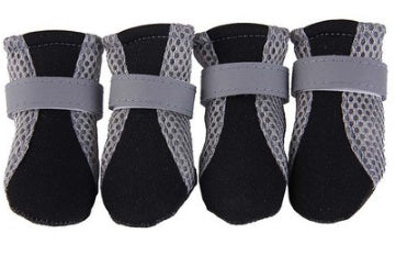 Four black breathable dog shoes with gray mesh sides and gray adjustable straps