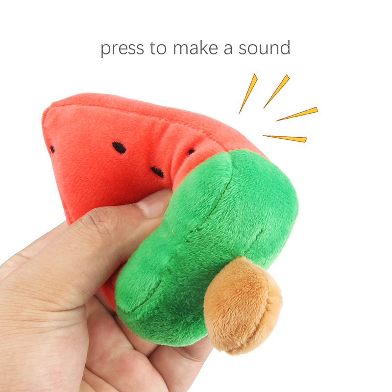 Hand squeezing the watermelon plush dog toy with text indicating it makes a sound when pressed