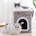 Load image into Gallery viewer, Two cats near a gray plush cat cave with white trim; one cat resting on top and the other lying in front of the entrance with a hanging mouse toy inside
