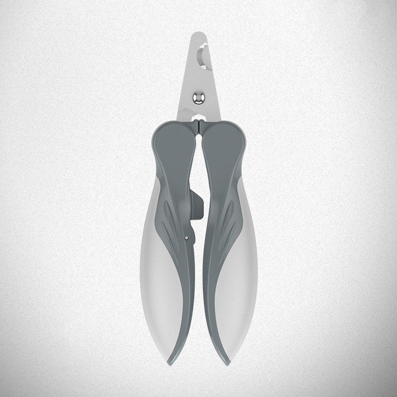 Closed white and gray pet nail clipper viewed from above on gray background