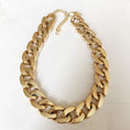 Load image into Gallery viewer, Big gold plastic chain necklace with adjustable clasp laying flat
