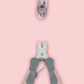 Load image into Gallery viewer, Open pink and gray pet nail clipper with visible stainless steel blades and a cat paw above
