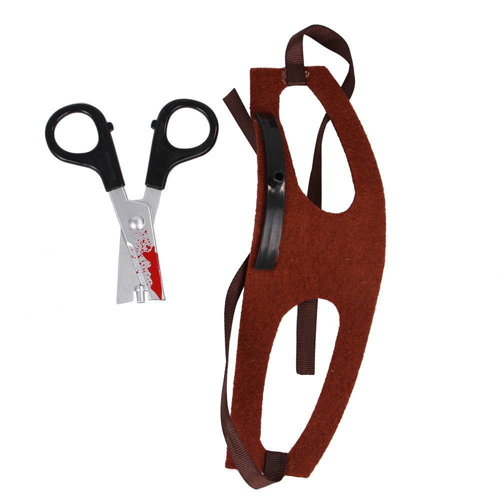 Picture of bloody scissors accessory next to brown cloth head strap