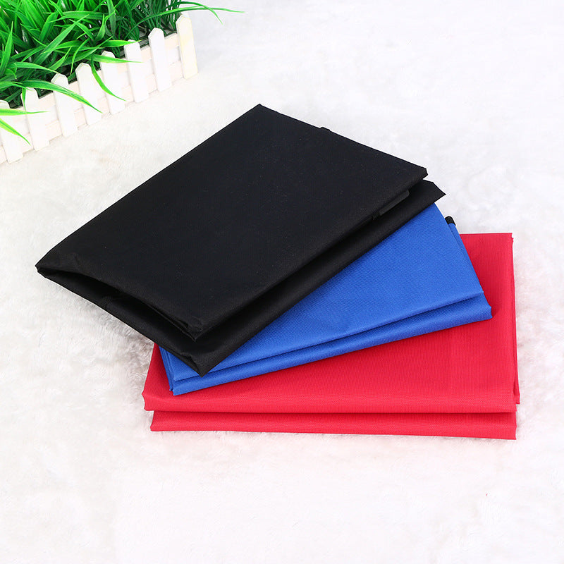 Folded waterproof pet seat covers in red, blue, and black colors stacked