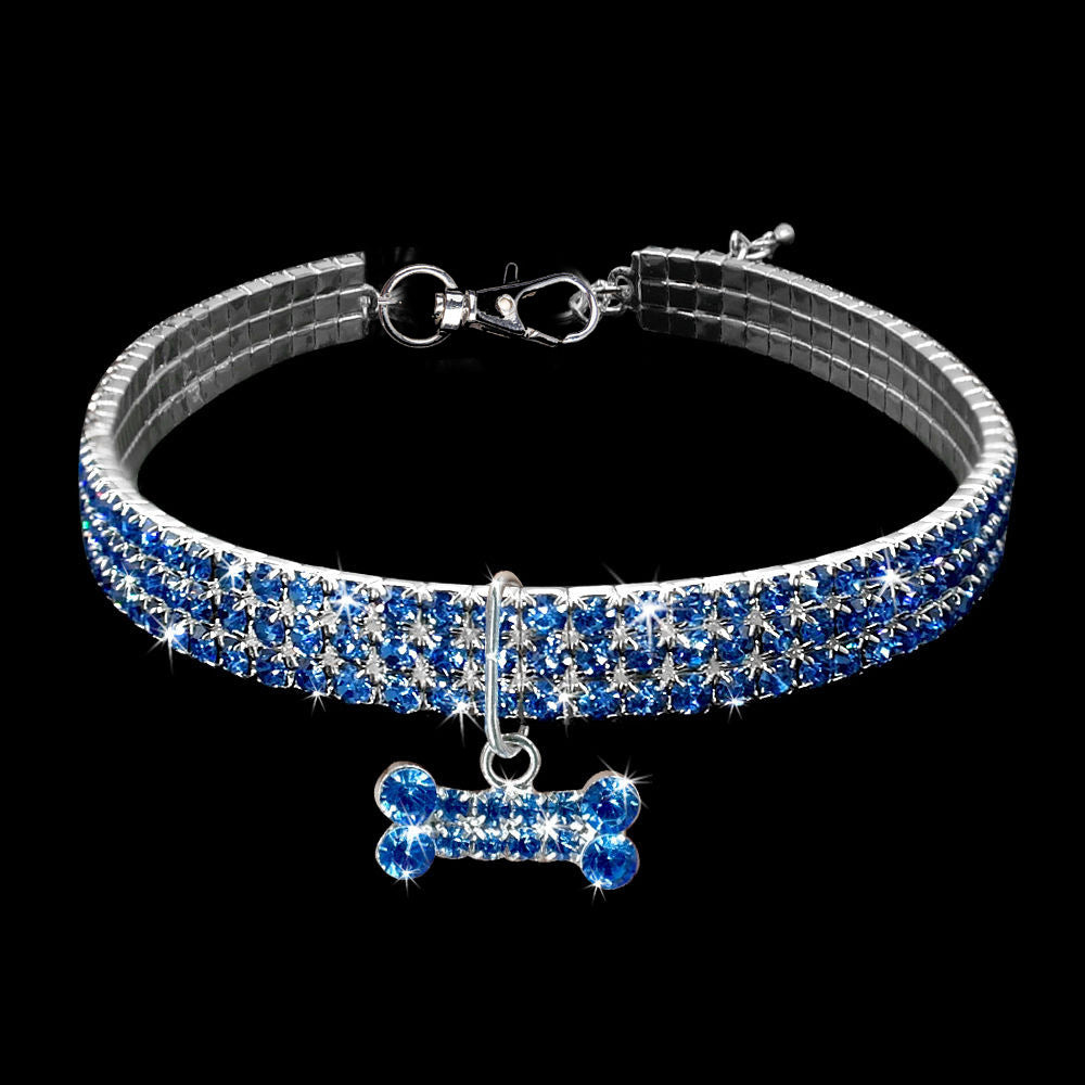 Blue rhinestone dog collar with crystal bone charm displayed on black background