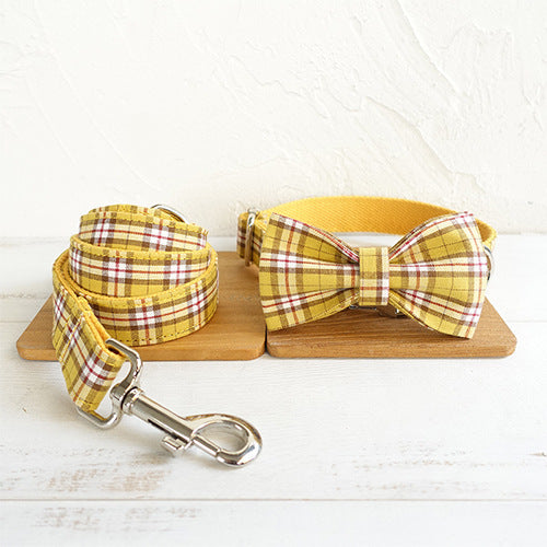 Plaid bowknot dog collar paired with matching leash displayed side by side
