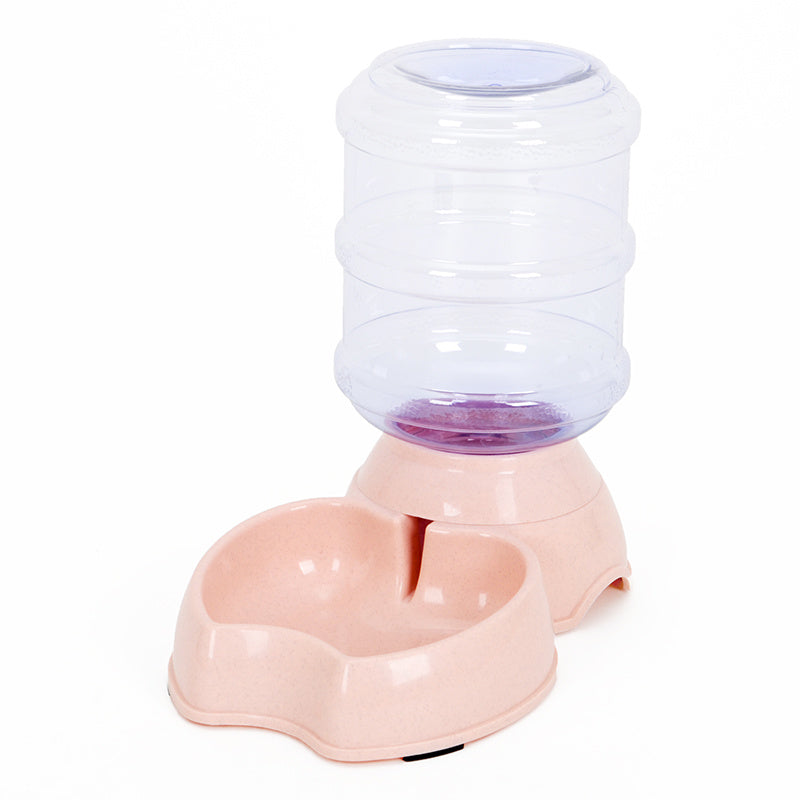 Pink pet feeding station with large transparent water container and curved food bowl base