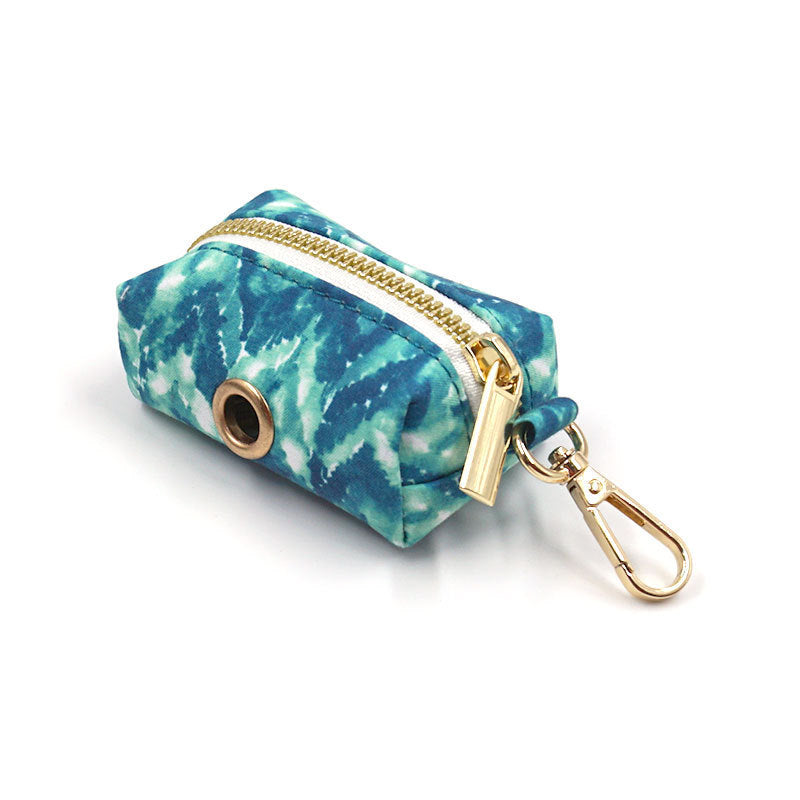 Close-up of blue tie-dye zippered waste bag holder with gold clip