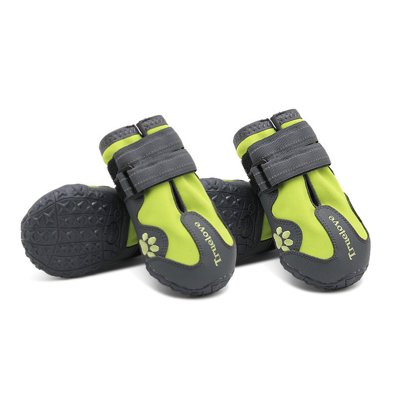 Pair of green and gray waterproof dog shoes with velcro straps displayed on white background