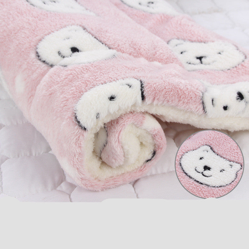 Rolled pink plush pet blanket with white bear faces and soft fleece lining