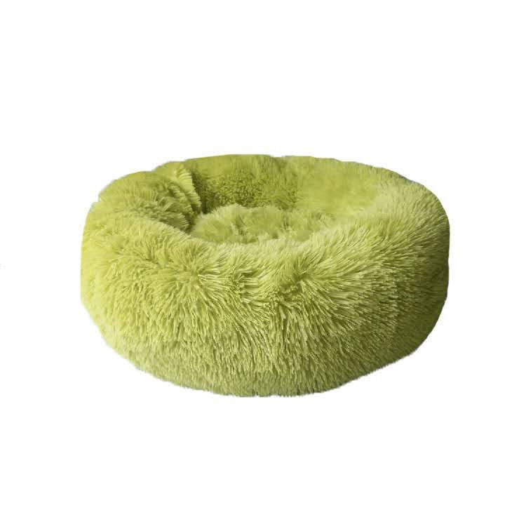 Light green round plush pet nest bed isolated on white background