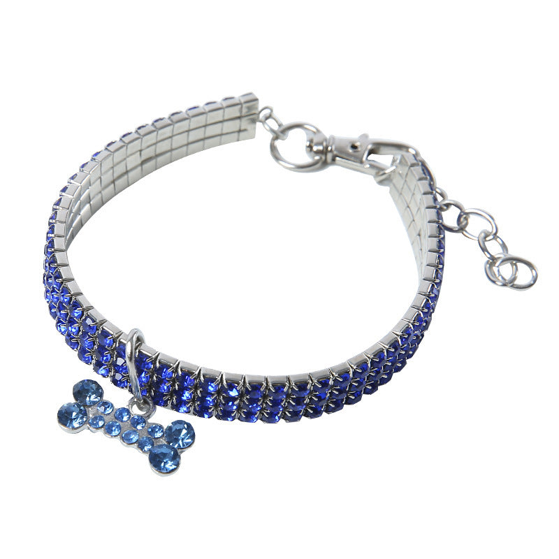 Blue rhinestone collar laid flat showing adjustable metal clasp