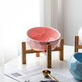 Load image into Gallery viewer, Pink ceramic pet bowl on bamboo stand in bright natural light
