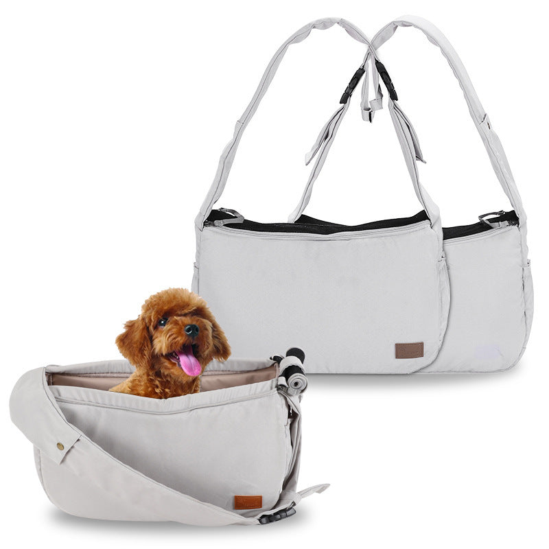 Light gray pet travel shoulder bag shown fully opened with small brown dog inside