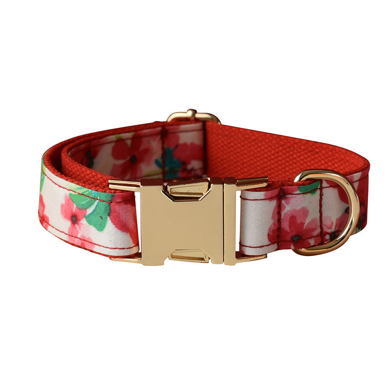 Rolled up red floral dog leash with gold clasp