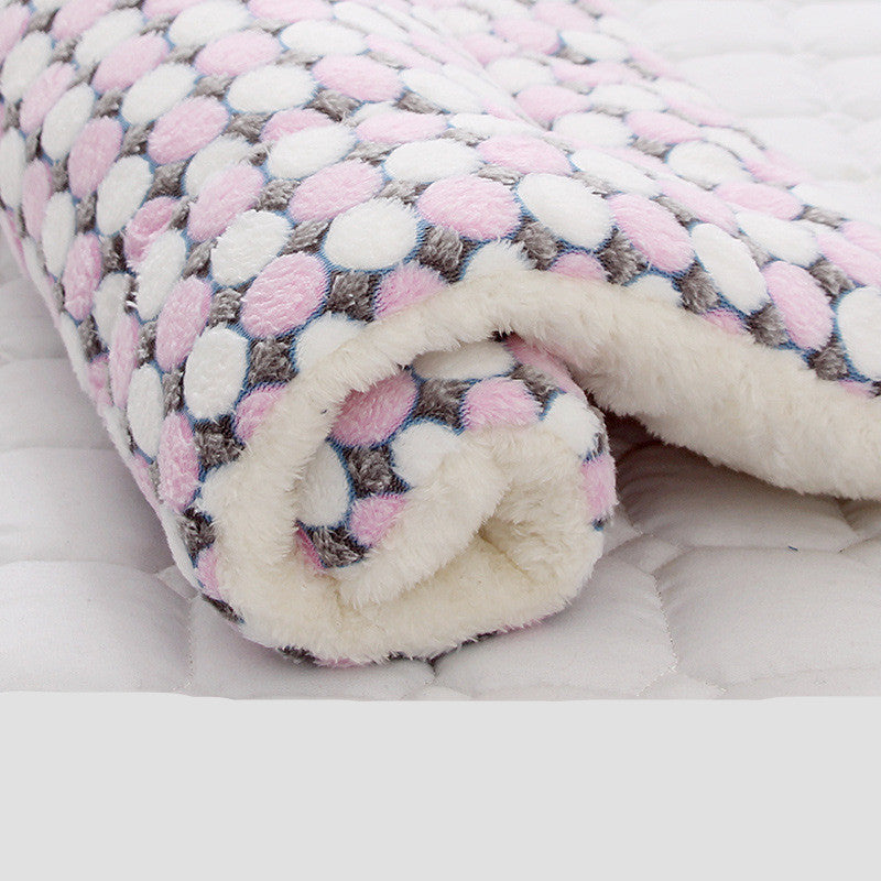 Rolled pet blanket with pink and white pebble pattern and thick fleece interior