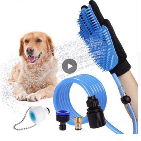 Black pet bathing glove with silicone blue bristles attached to blue hose and faucet adapters, spraying water on a happy golden retriever dog